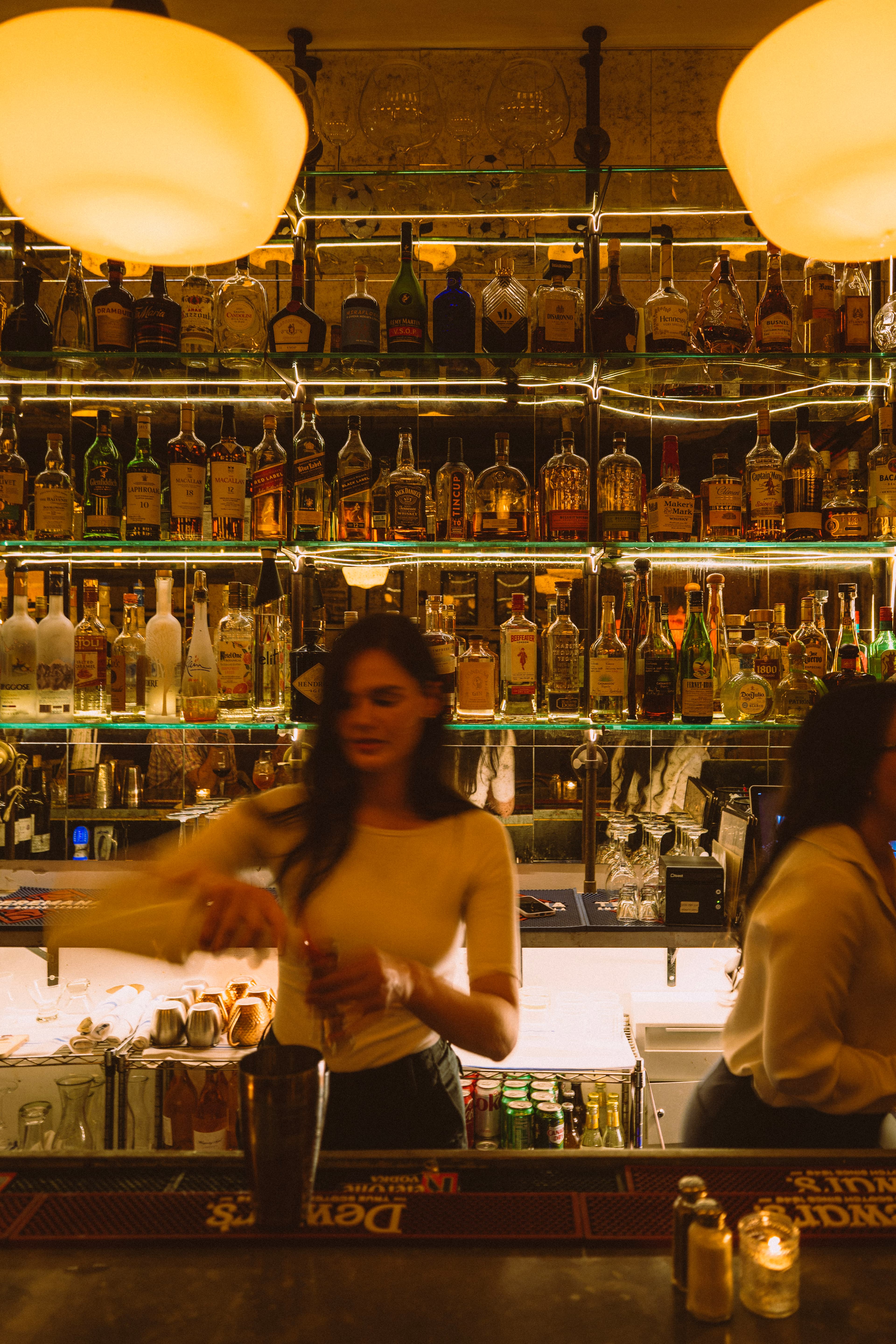 A bartender pouring a drink at the Barbès bar