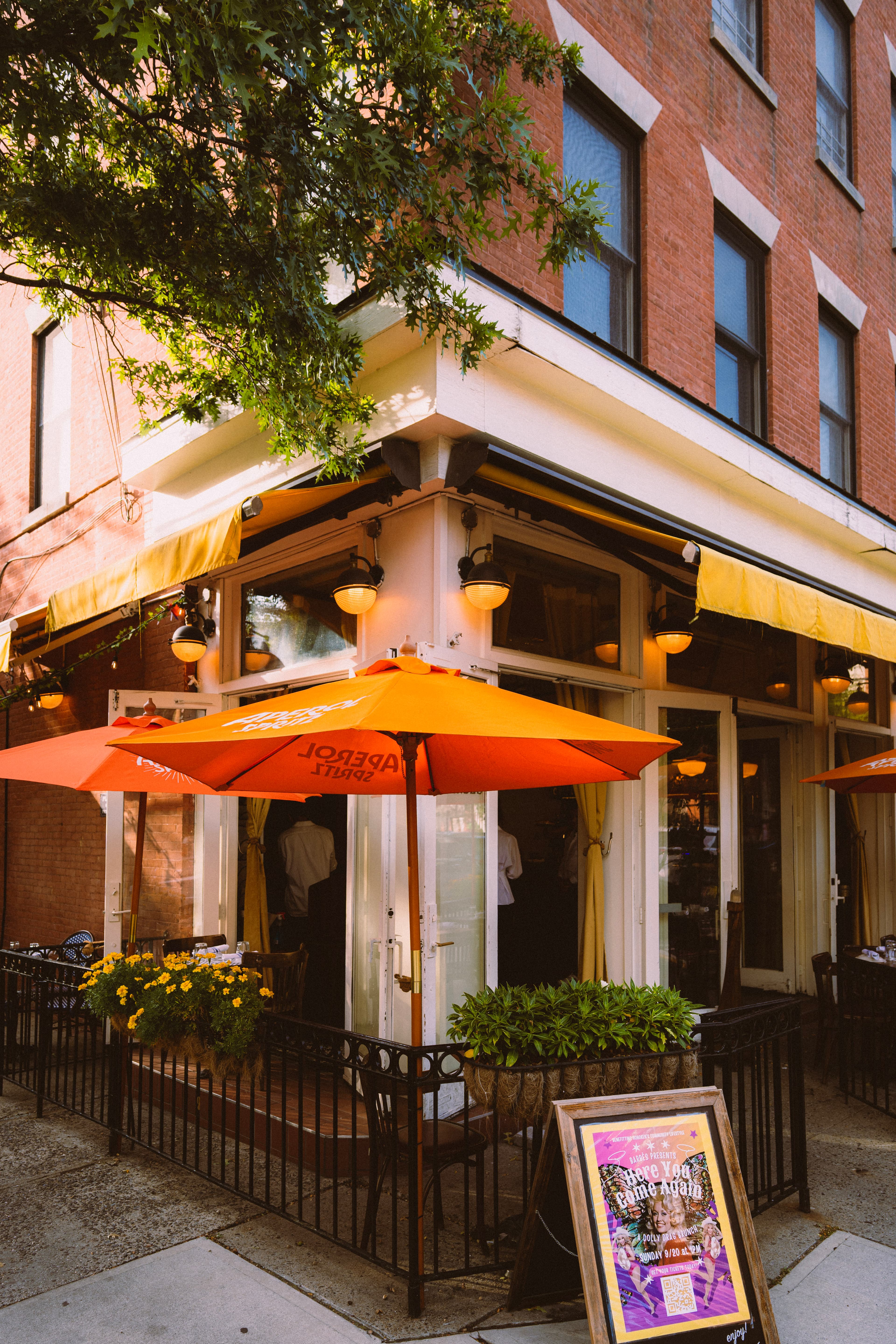 The Barbès corner storefront with an orange umbrella