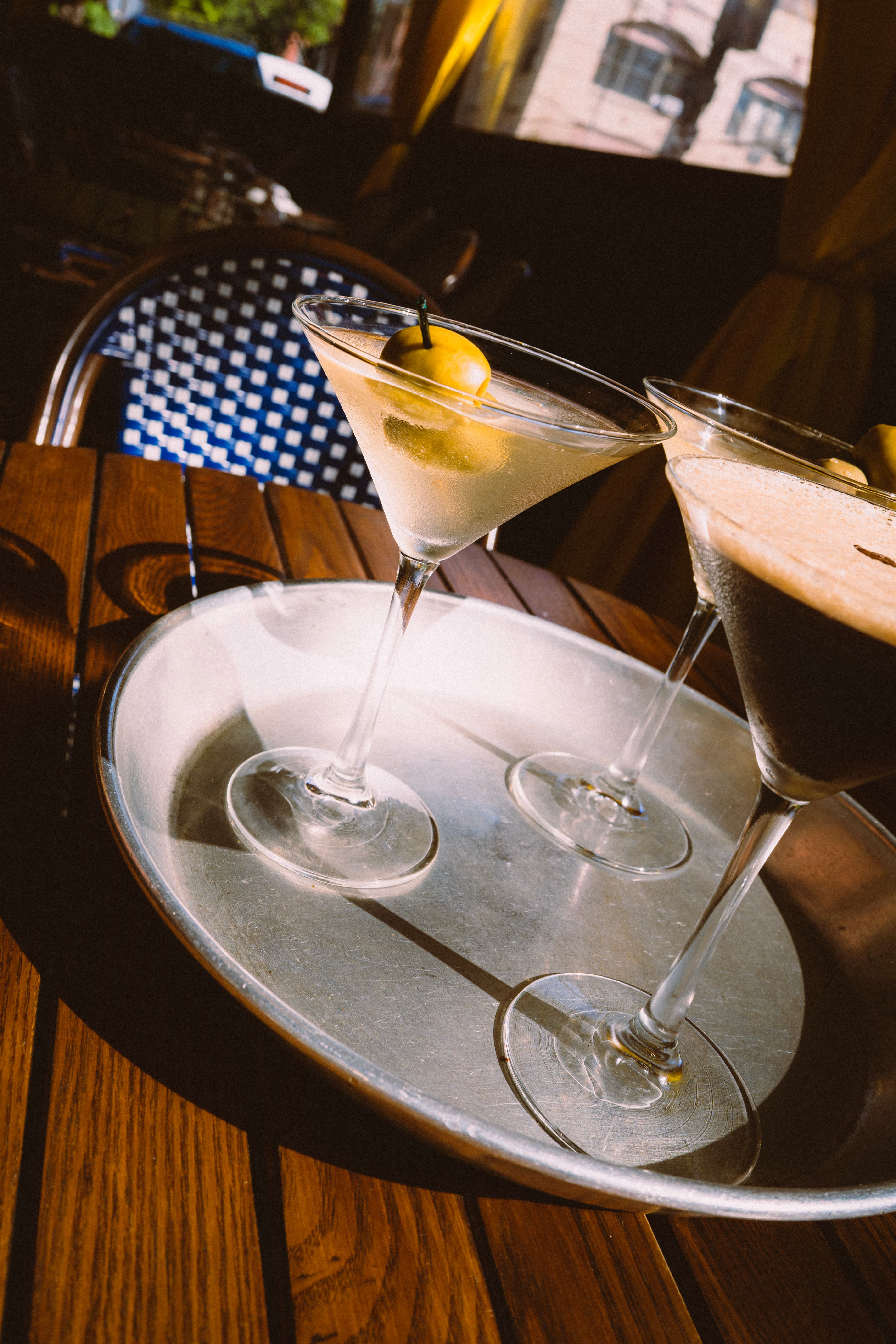Martinis on a metal tray in the afternoon sun