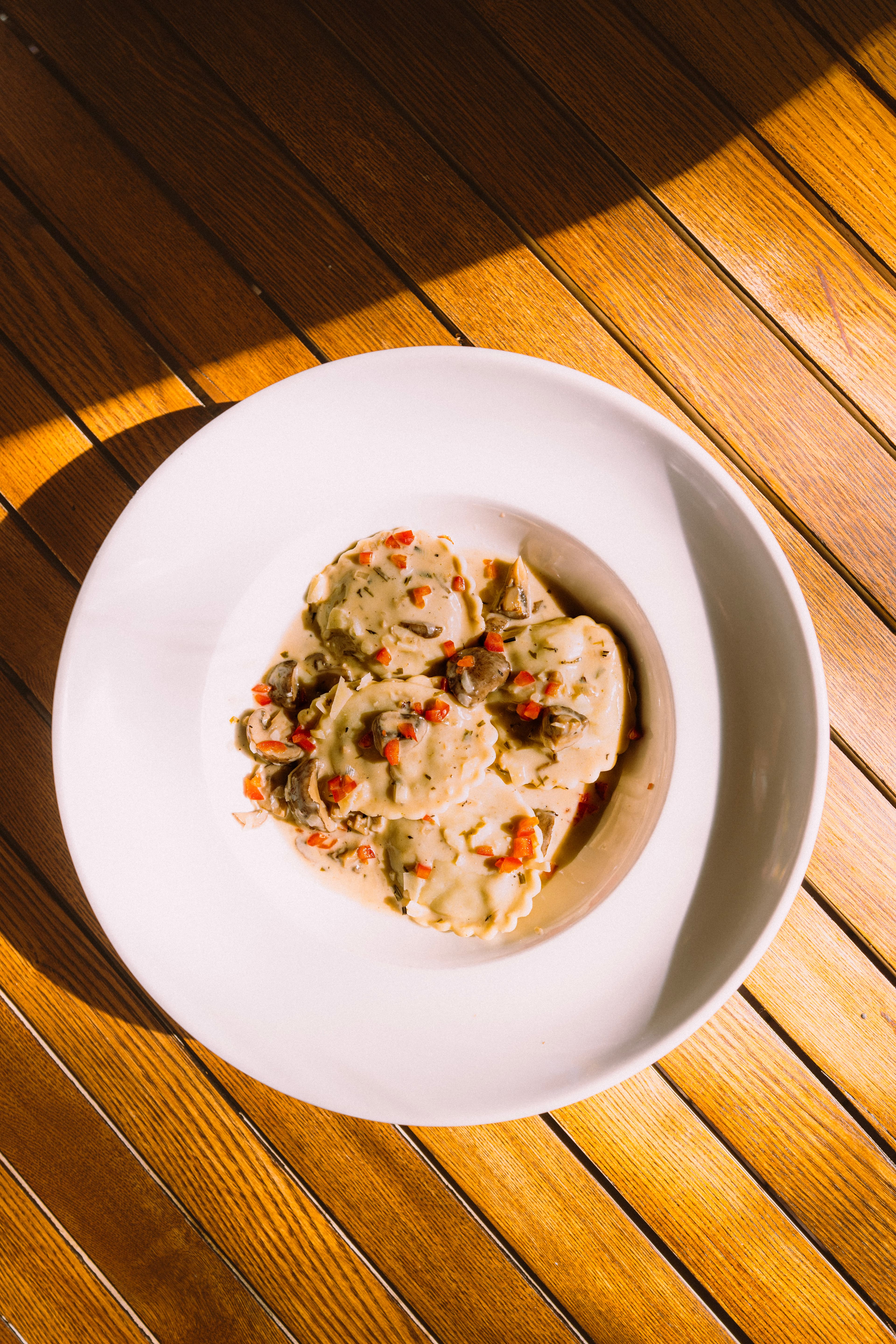 Ravioli in a creamy sauce with red pepper, seen from above