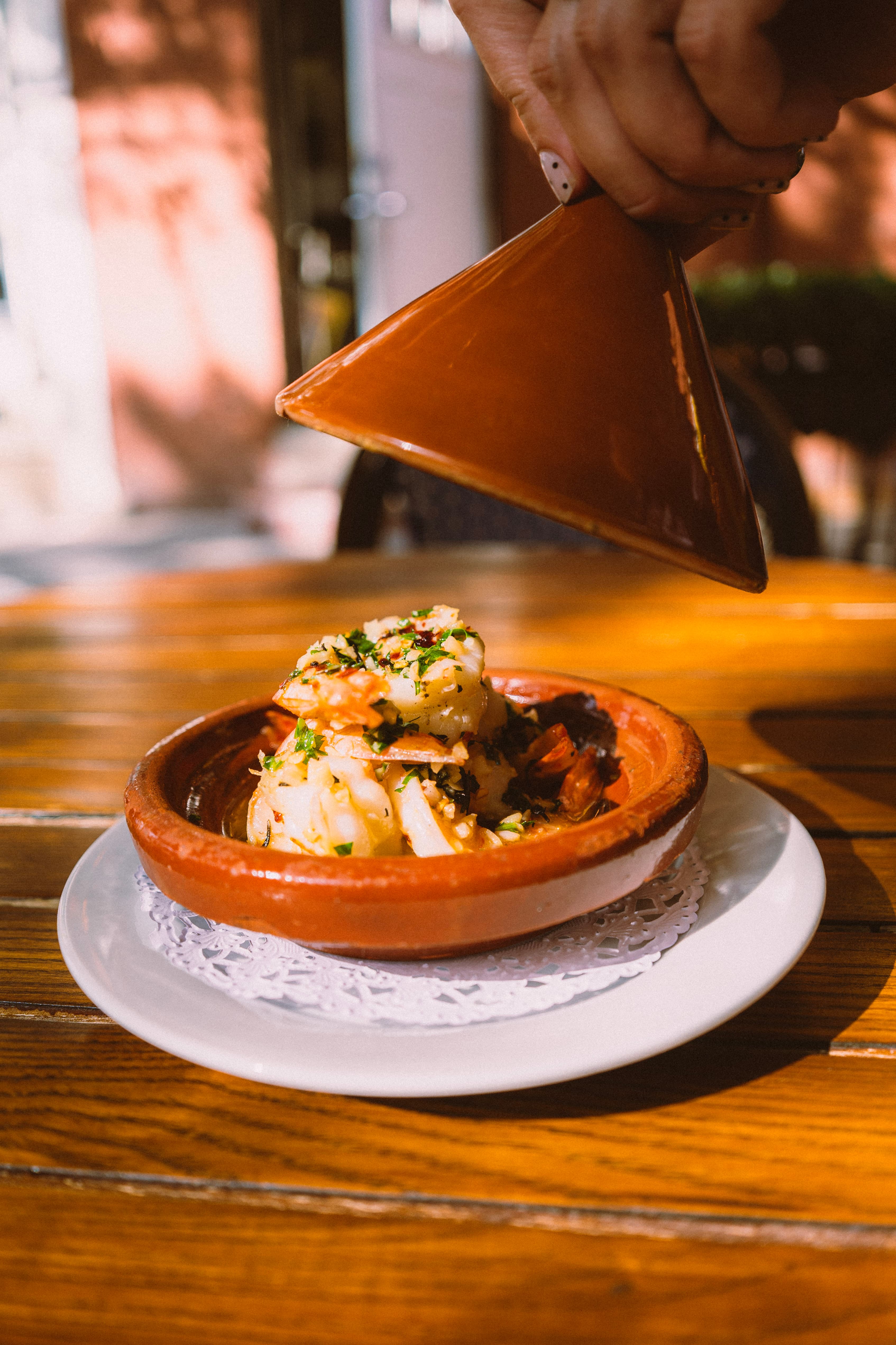 Lifting the lid off a clay tagine of shrimp
