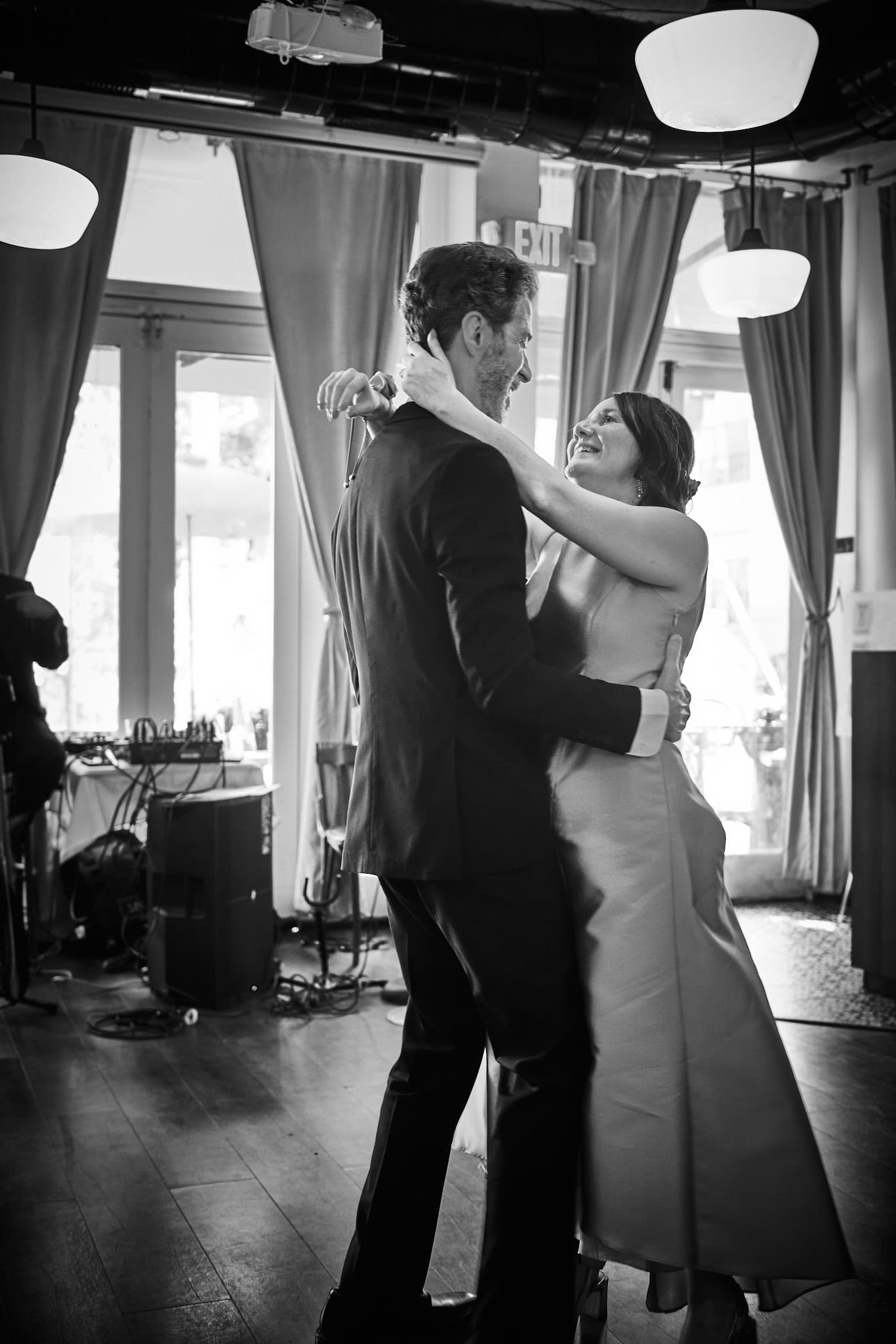 A newlywed couple embracing on the dance floor at Barbès